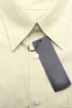 Close up view of a generic line pattern yellow business shirt with a blank label