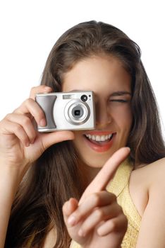 Smiling model holding digital camera and making a shot
