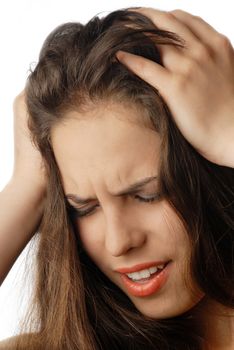 Woman suffering from headache and pressing her head by arms