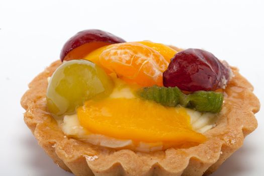 sweet cake with fruits isolated on white