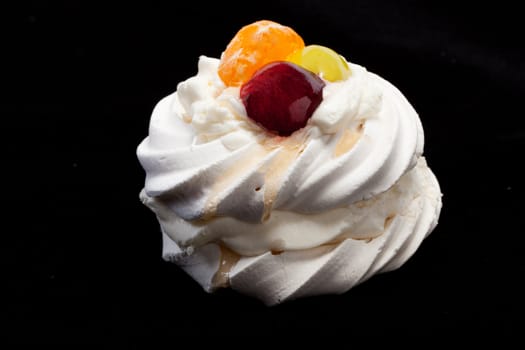 sweet cake with fruits isolated on black