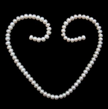 White pearls on the black silk can use as background 