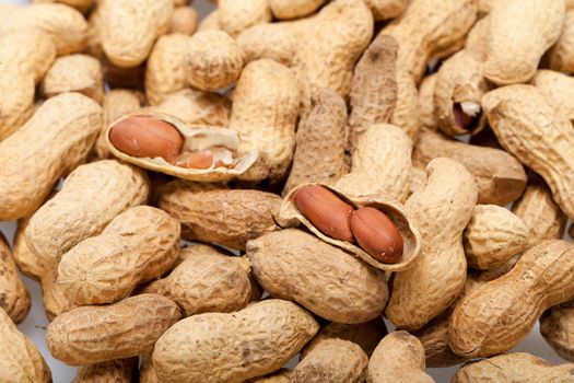 
Dried peanuts in closeup on the white background