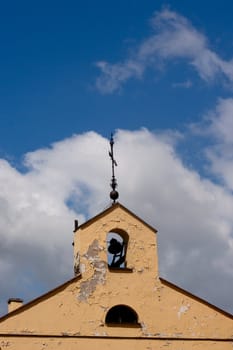 An old sandy belltawer and blue sky in Vilnius
