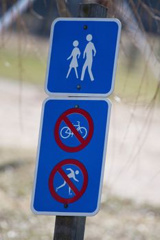 Pedestrian walking permitted, No bicycling or skiing signs.