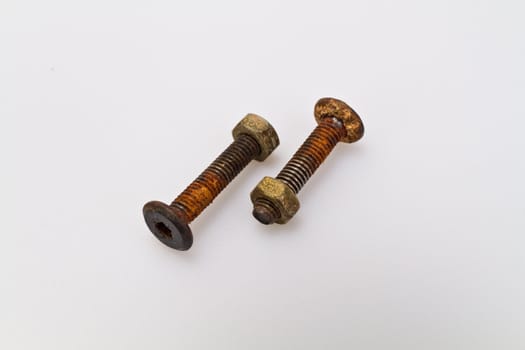 Old and rusty bolt and nut on white background