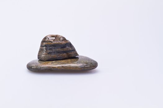 two stones stacking on each ther on white background in landscape orentation