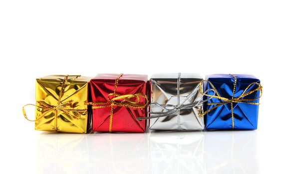 Four different colored christmas gifts shot on a solid white background.