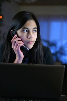 Young teen girl taking call while home alone.