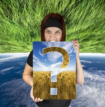 Redhead girl holding a canvas with a question mark.

Shot in studio. Composite background.