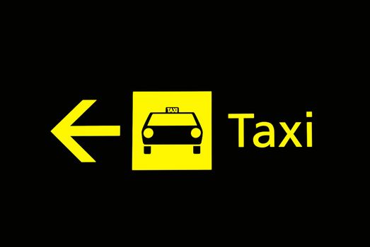 A view of airport taxi sign in black background
