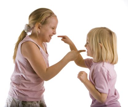 Sisters arguing with pointed fingers wearing pink