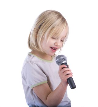 Child singing into microphone isolated on white
background