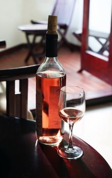 Bottle with the wine, the filled glass