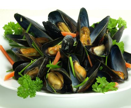 A plate of boiled and garnished mussels.