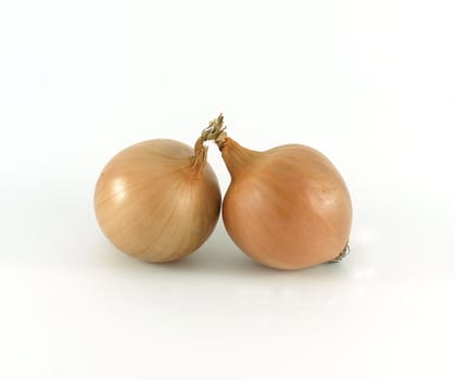 Two whole onions on white background