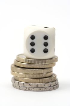 Dice on stack of coins,close up,over white