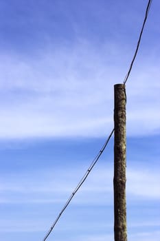 A distribution line over blue sky