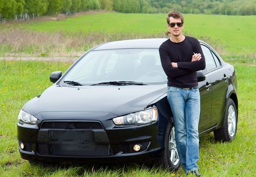 young man against the black car