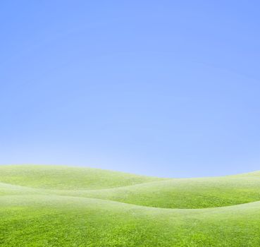 A simple tranquil beautiful multiple S-curved horizon with blue sky and green grass.