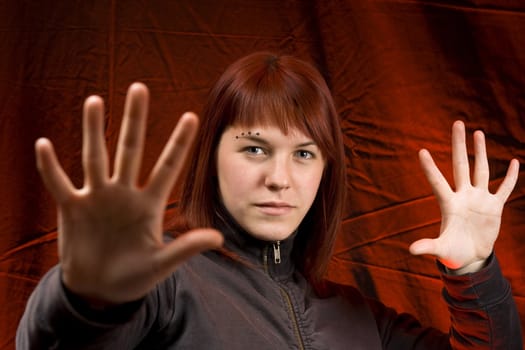 Girl holding her hands in front of the camera, stopping someone.