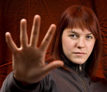 Girl holding her hands in front of the camera, stopping someone.