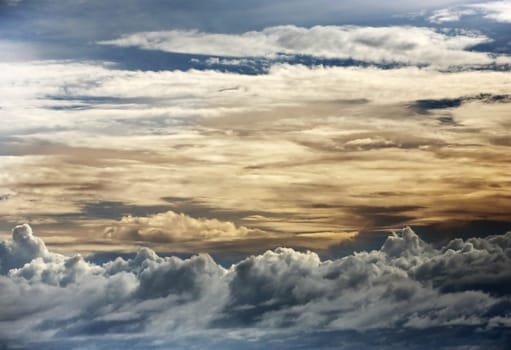 The image of yellow clouds on a background of the dark blue sky