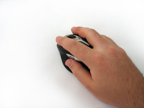 A hand guiding a modern wireless mouse - isolated over white.