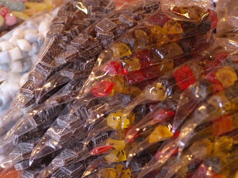 bags with different kinds of sweets on market stall