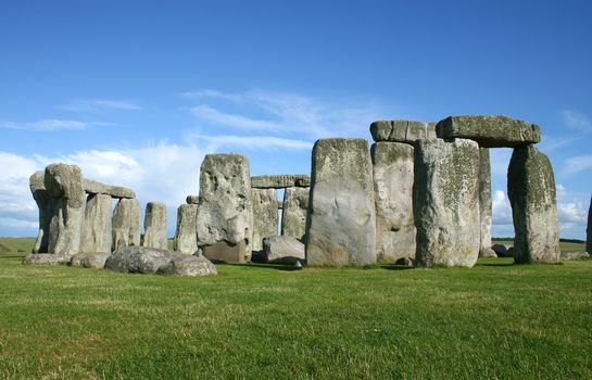 stonehenge with blue sky and green grass