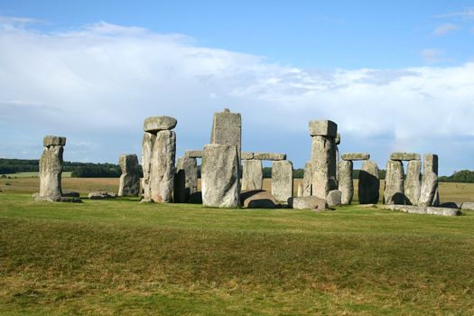 stonehenge with blue sky and green grass