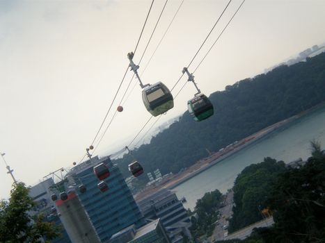 String of cable cars in singapore, shot taken from mount faber