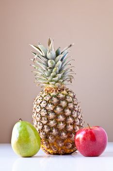 Trio of fruits on white with taupe brown background. The concepts depicted in this image are nutrition, good food choices, balanced diet and good for you.