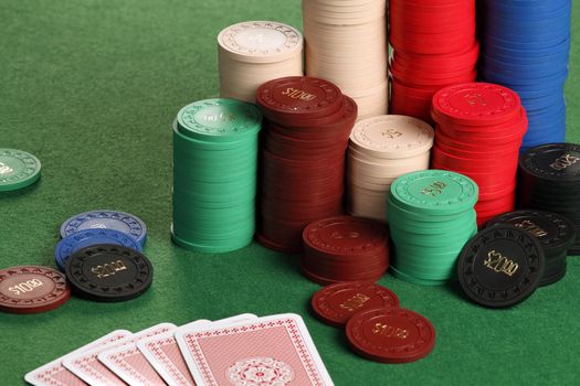 Photo of a poker table with gambling chips and cards.