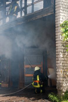 Fireman fighting a fire in a burning building