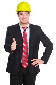 Engineer or architect showing thumbs up success hand sign in suit and construction work protection helmet hat isolated on white background. Young happy successful male professional.