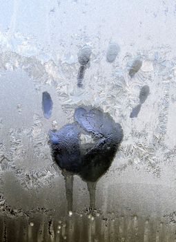 Handprint on ice window, sign desires spring