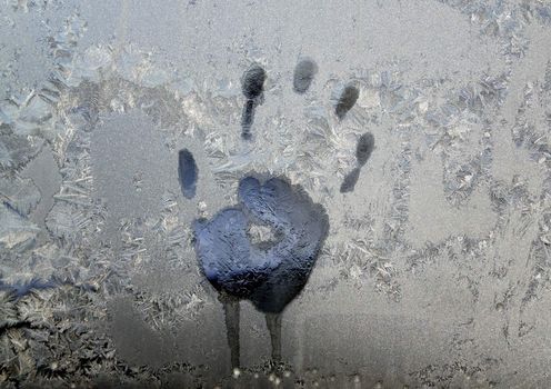 Handprint on ice window, sign desires spring