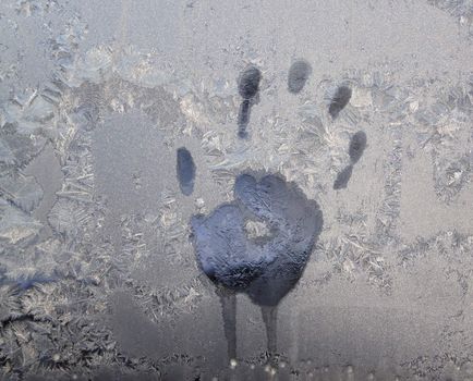 Handprint on ice window, sign desires spring