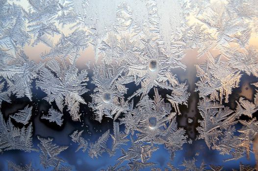 Ice pattern on window, winter sunset