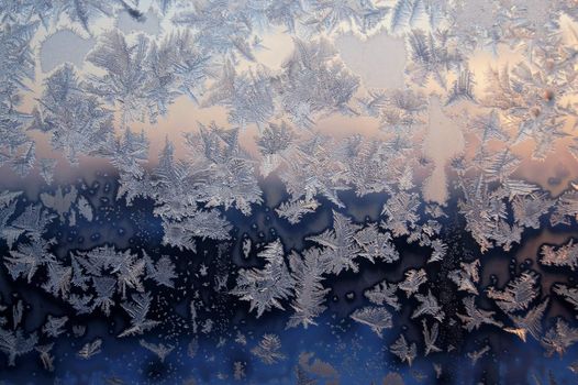 Ice pattern on window, winter sunset