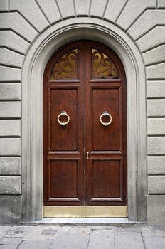 Fragment of old stone building with nice wooden door