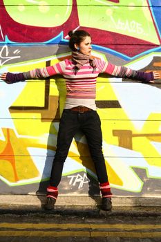 Young woman with a graffiti background