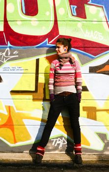 Young woman with a graffiti background