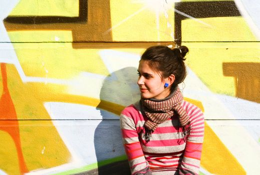 Young woman with a graffiti background