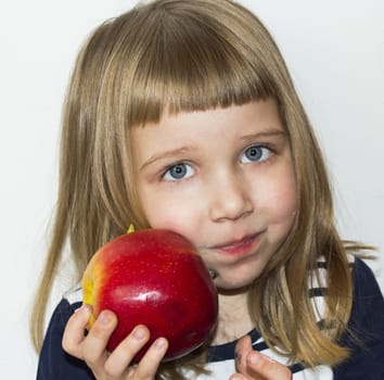 little girl is eating apple