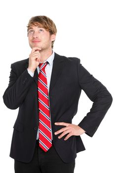 Thinking businessman in suit. Young caucasian business man pensive contemplating an idea isolated on white background.