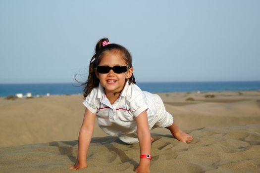 A happy smiling child in a desert