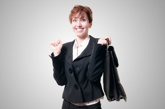 happy business woman with briefcase on gray background