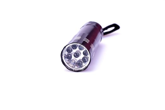 black LED torchlight on white background in close up view